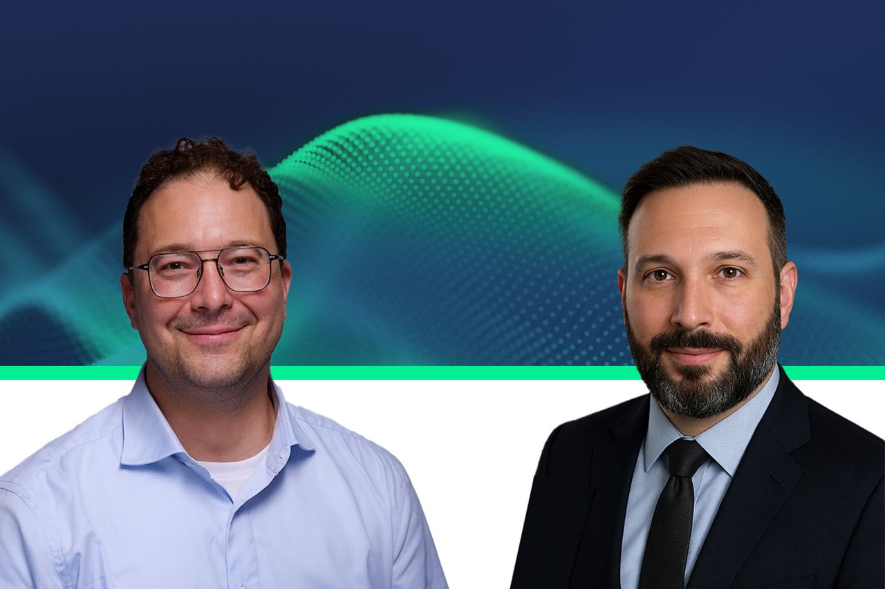 Two professionals posed against a dark blue abstract background with green wave graphics
