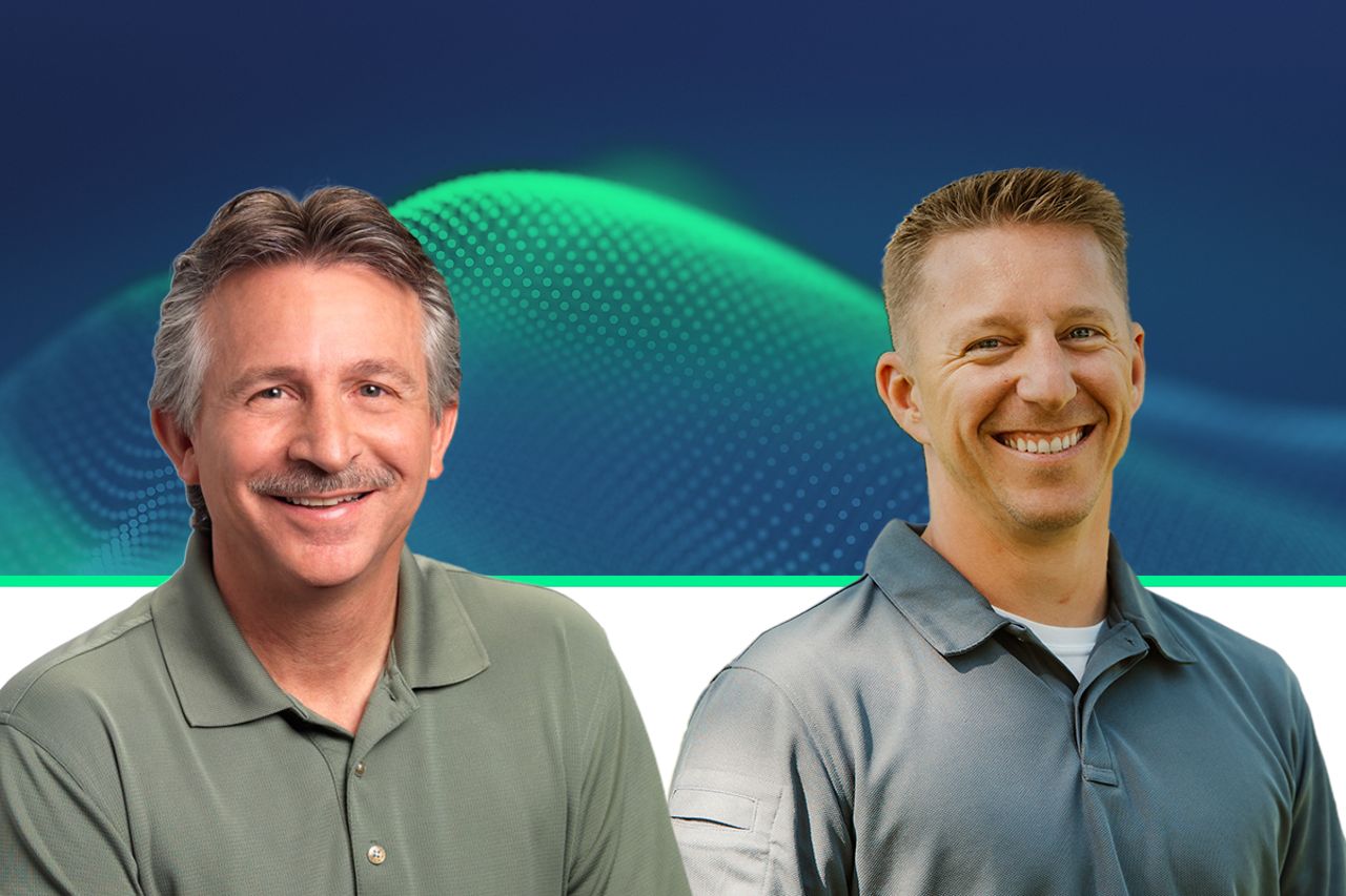 Two smiling professionals in polo shirts against a blue digital wave background