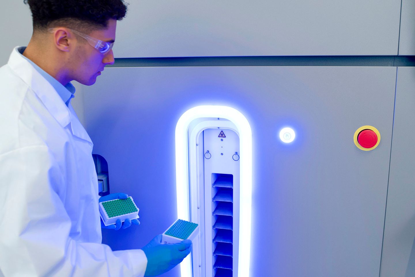 Lab tech loading samples into Hamilton BiOS