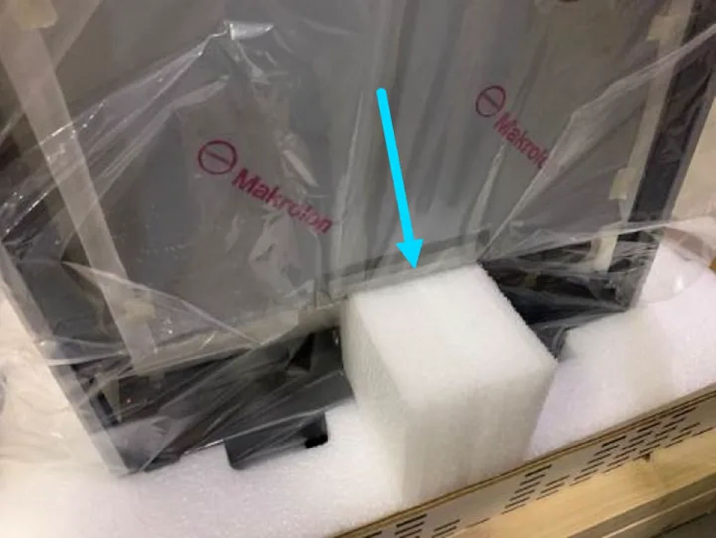 Makrolon-labeled polycarbonate sheets packed in foam inserts and plastic wrap inside a shipping crate