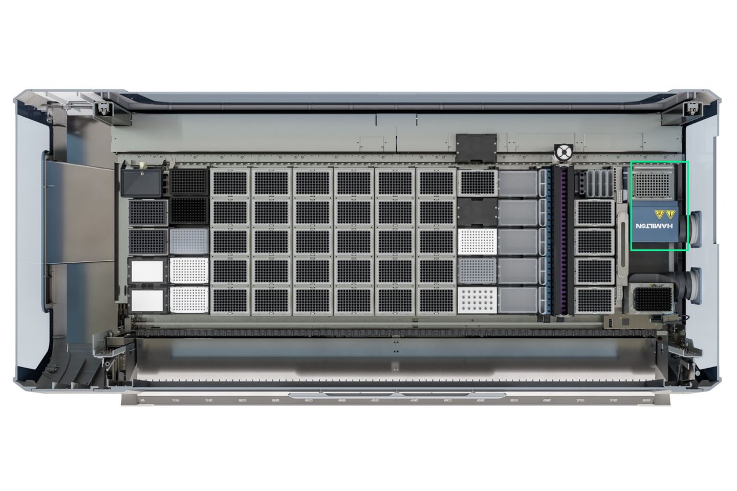 Top-down view of an open Hamilton automated liquid handling instrument deck with labeled modules and a green highlight box