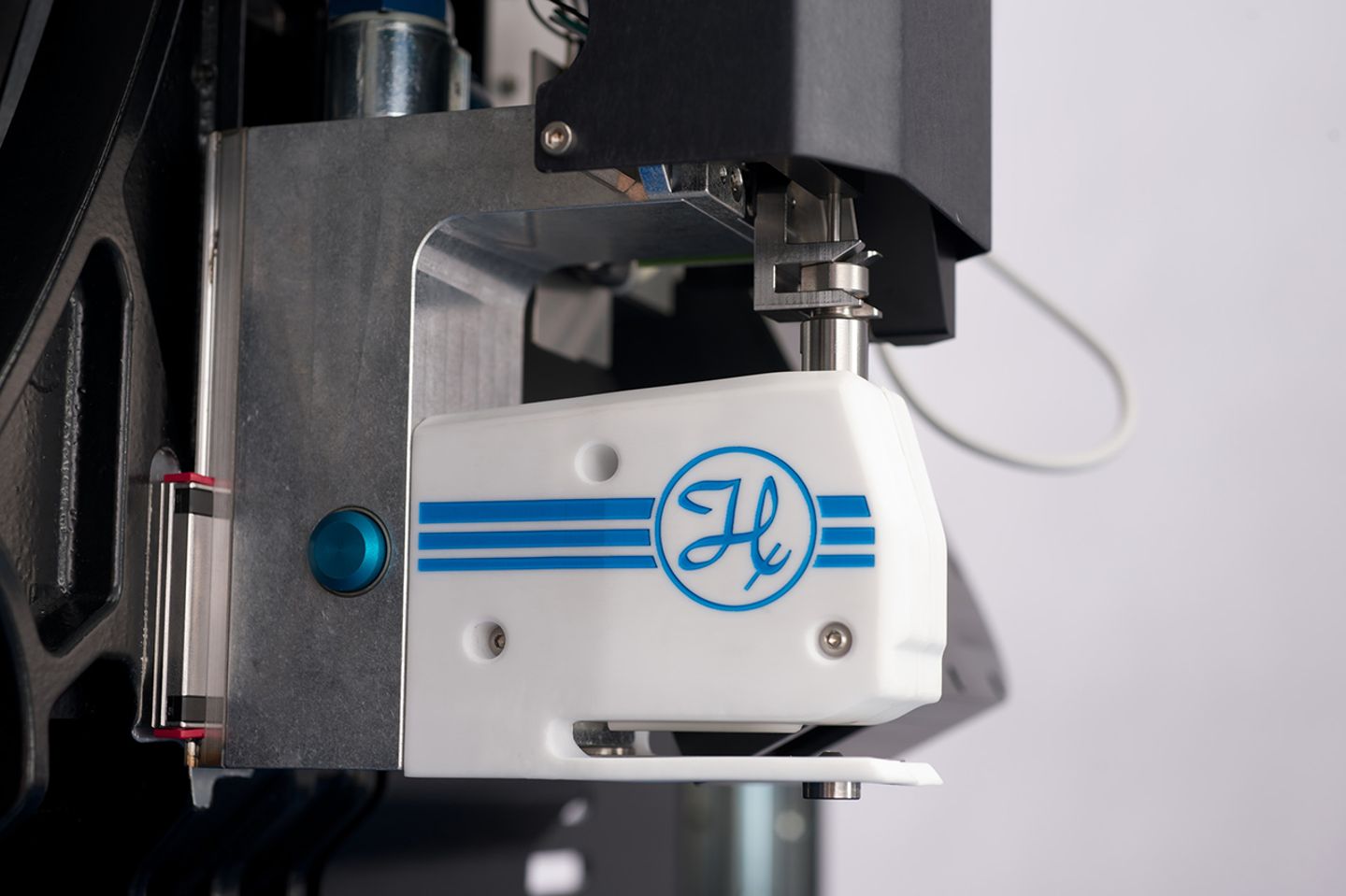 Close-up of a white Hamilton-branded pipetting head module mounted on a metal frame, featuring blue stripe logo