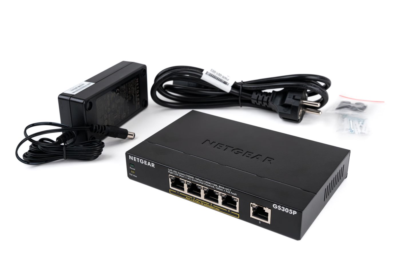 Netgear GS305P 5-port network switch with power adapter, power cord, and mounting screws