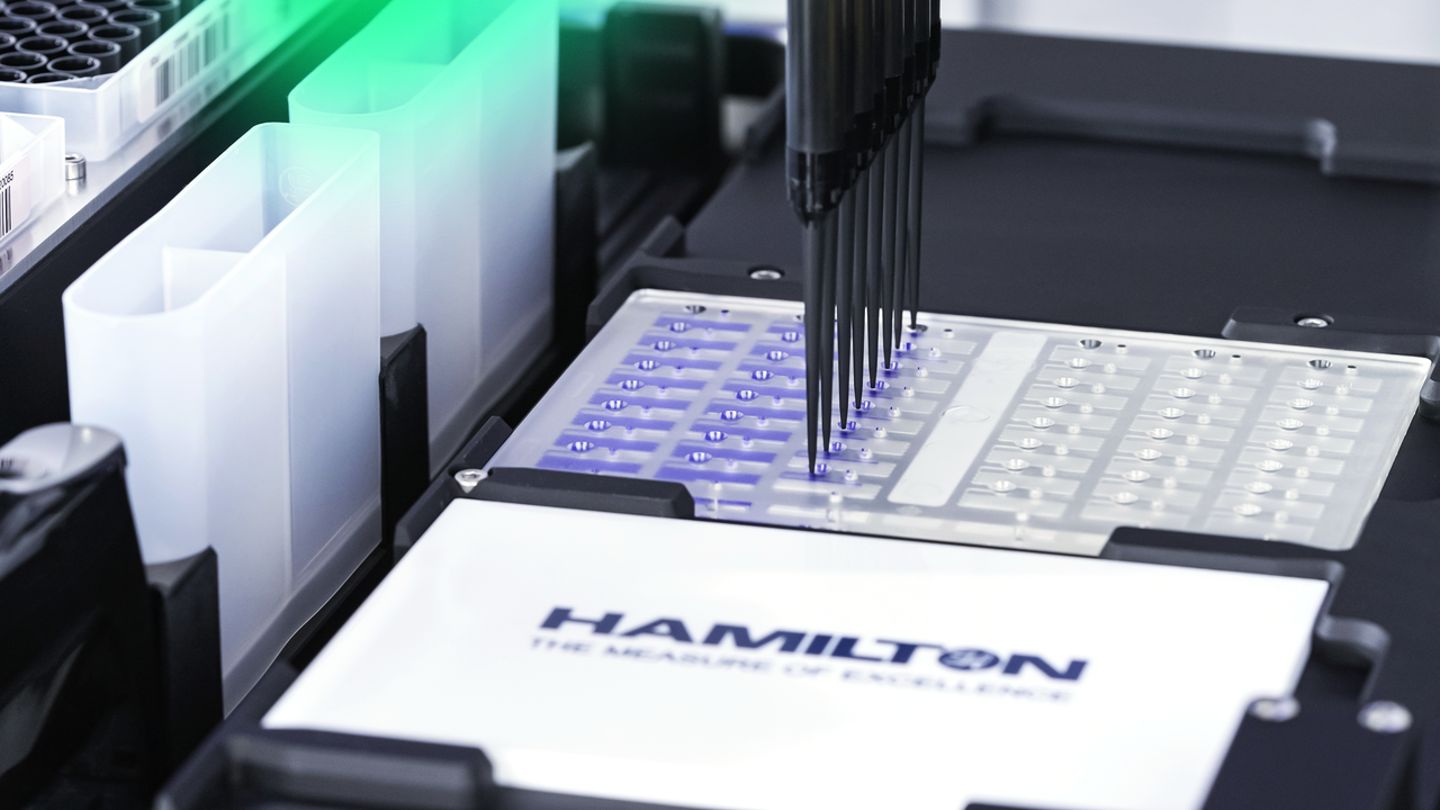 Hamilton automated liquid handler dispensing blue liquid into a multi-well plate using a multi-channel pipette head.