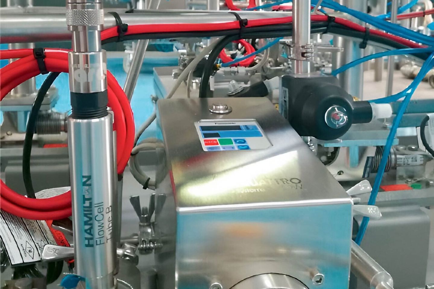 Hamilton FlowCell Tube B sensor installed in a stainless steel bioprocess system with tubing and instrumentation