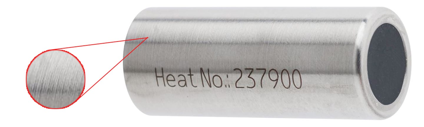 Stainless steel hollow cylindrical component marked "Heat No.: 237900" with a magnified inset showing surface grooves
