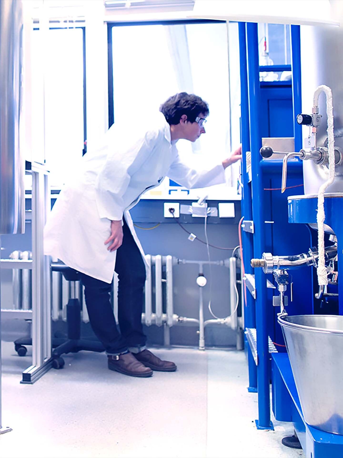Lab technician operating fermenter