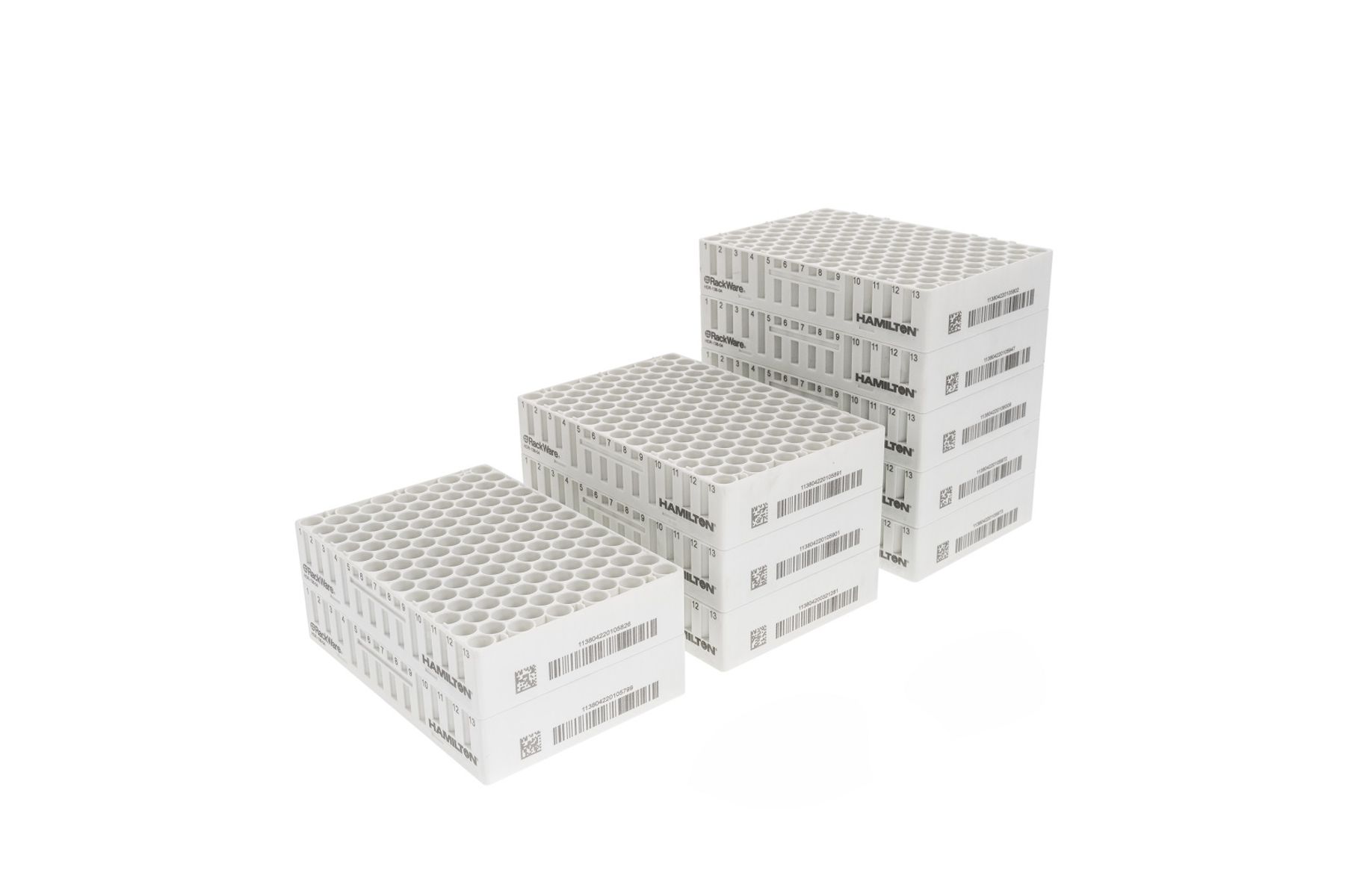 Three white Hamilton RackWare sample storage racks of varying heights, stacked and labeled with barcodes.