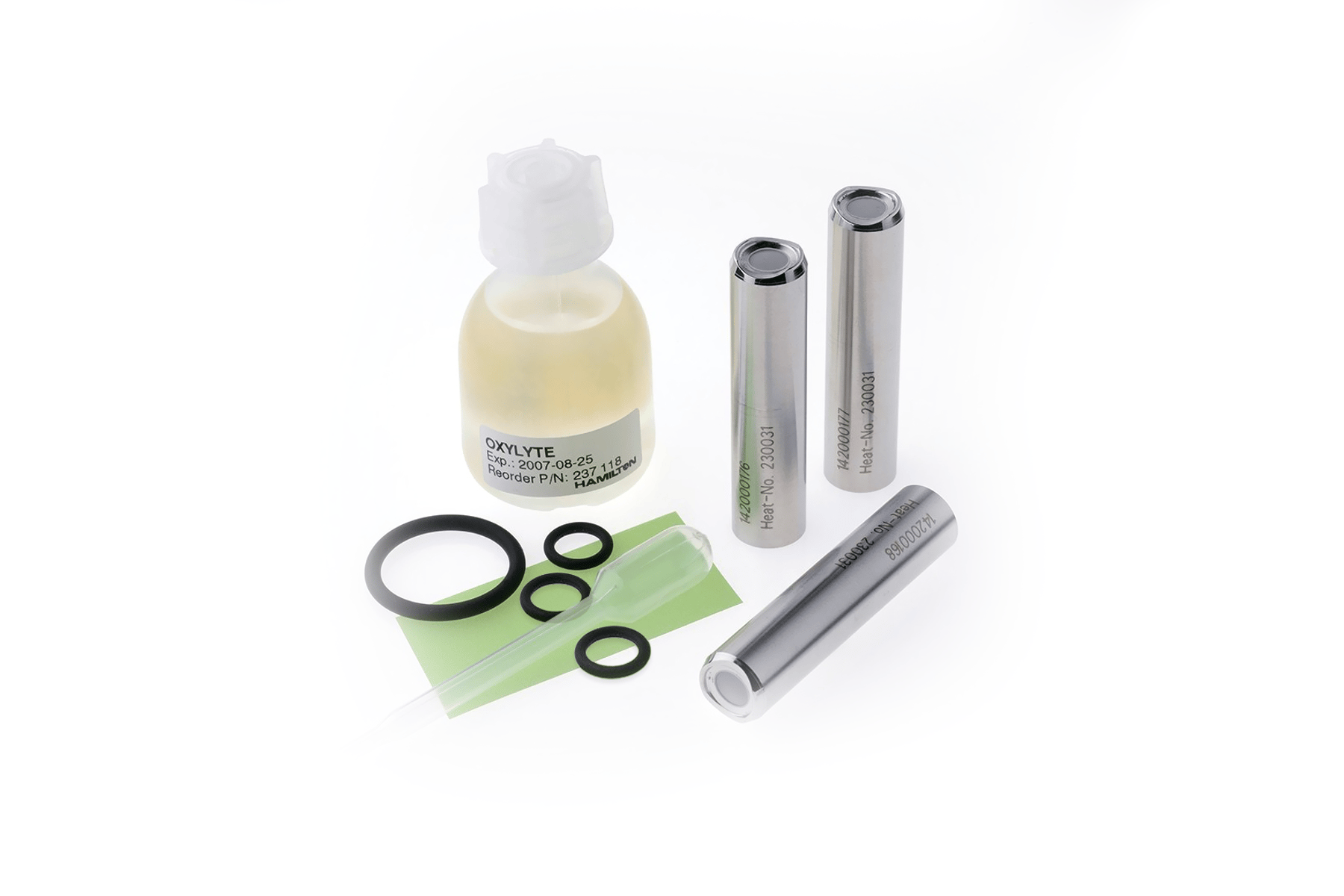 Oxylyte solution bottle, three stainless steel membrane caps, O-rings, and a small spatula on white background