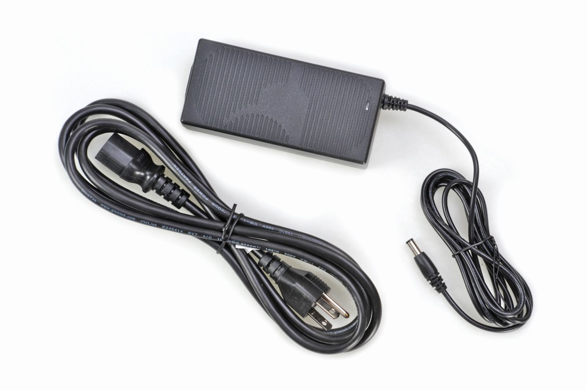 Black AC power adapter brick with detachable power cord and DC barrel connector cable on white background