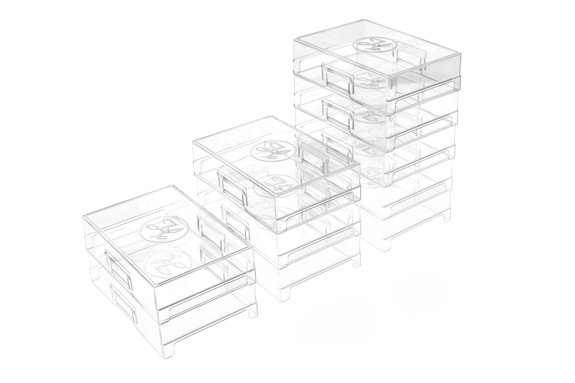 Clear stackable plastic storage boxes arranged in a staircase pattern, three stacks of increasing height