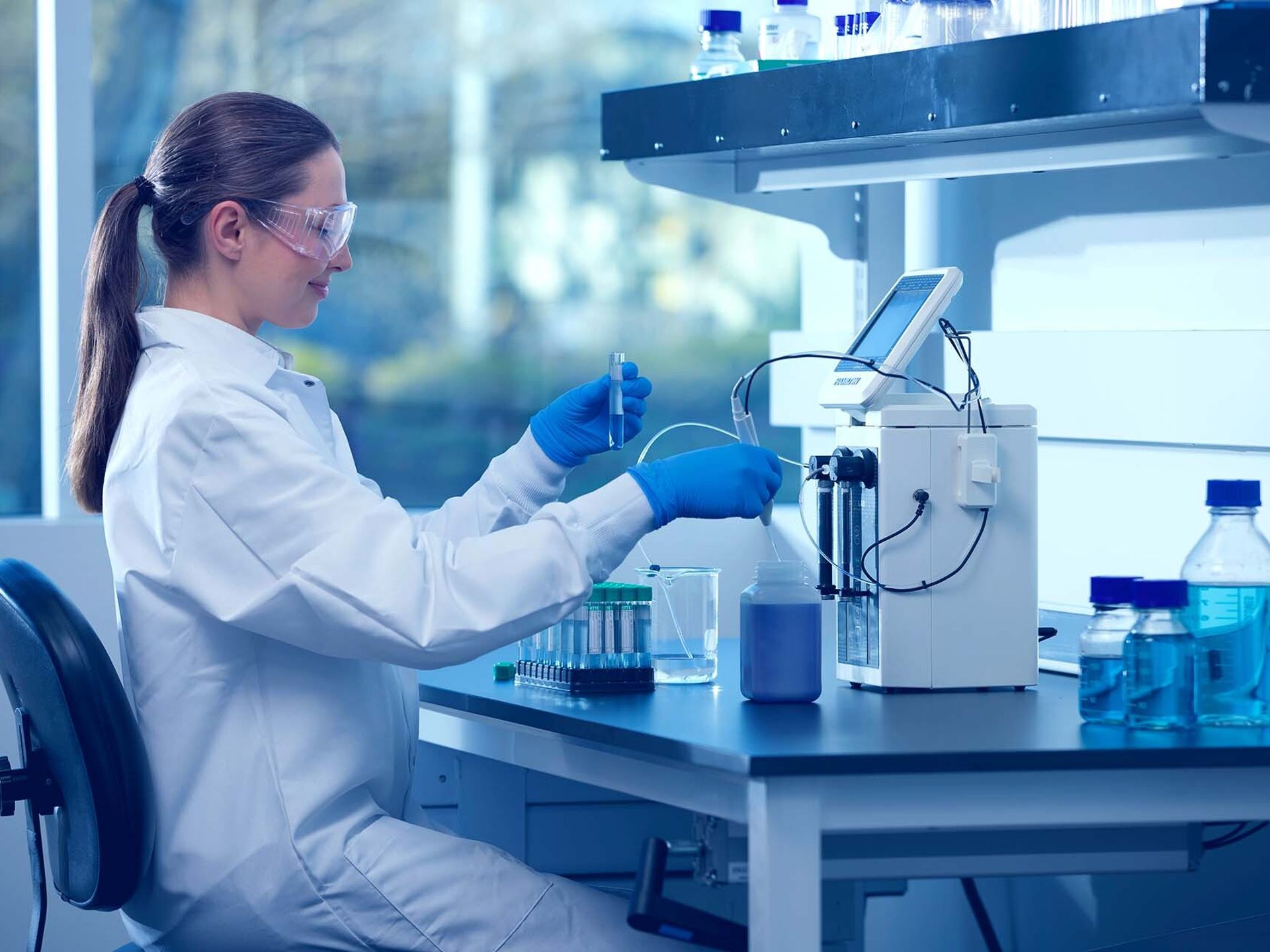 Scientist using a Hamilton dispenser