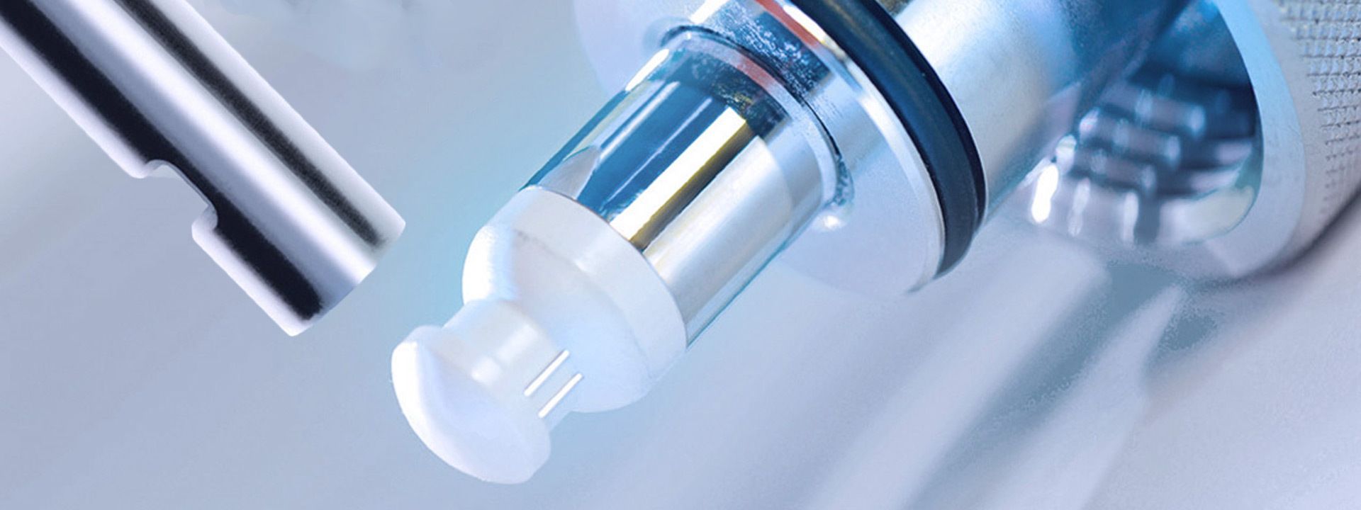 Close-up of a cell density sensor probe with white optical tip and cylindrical glass and metal body