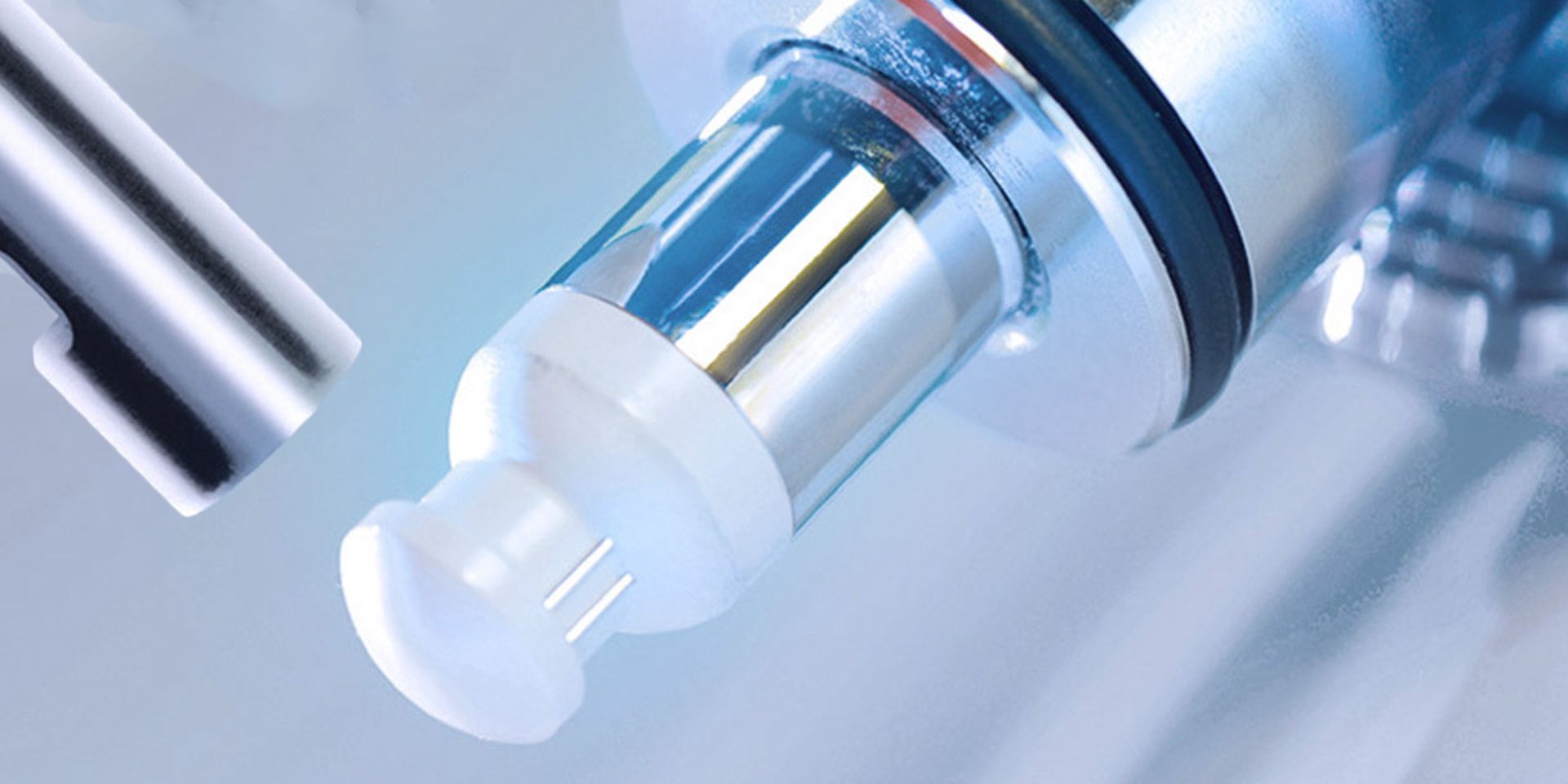 Close-up of a cell density sensor probe with white optical tip and cylindrical glass and metal body