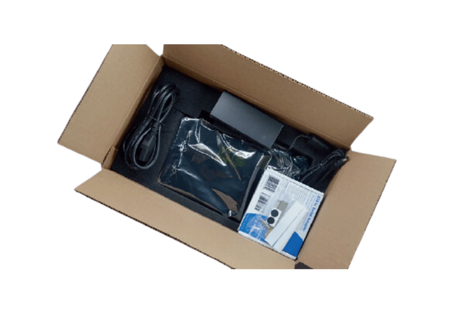 Open cardboard box containing black electronic device, power cable, accessories in anti-static bag, and small labeled box