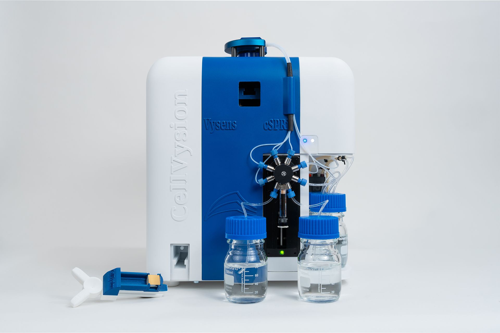 Vysens cSPRi CellVysion instrument with multi-port valve, tubing, and two 100 mL bottles on white background