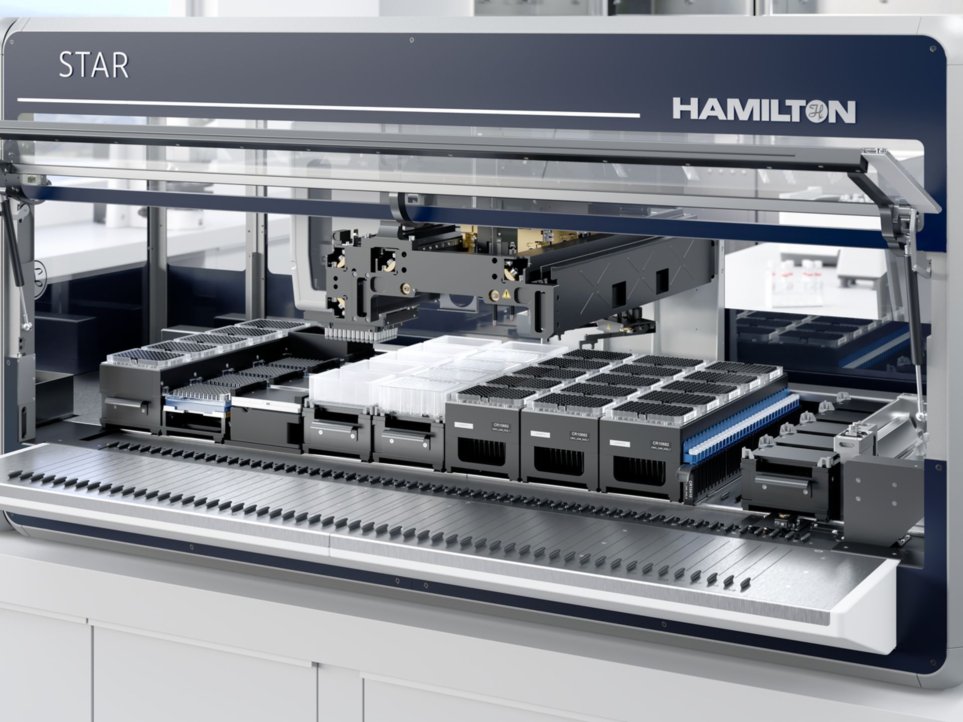 Hamilton STAR automated liquid handler deck with pipetting arm, microplates, tip racks, and reagent modules