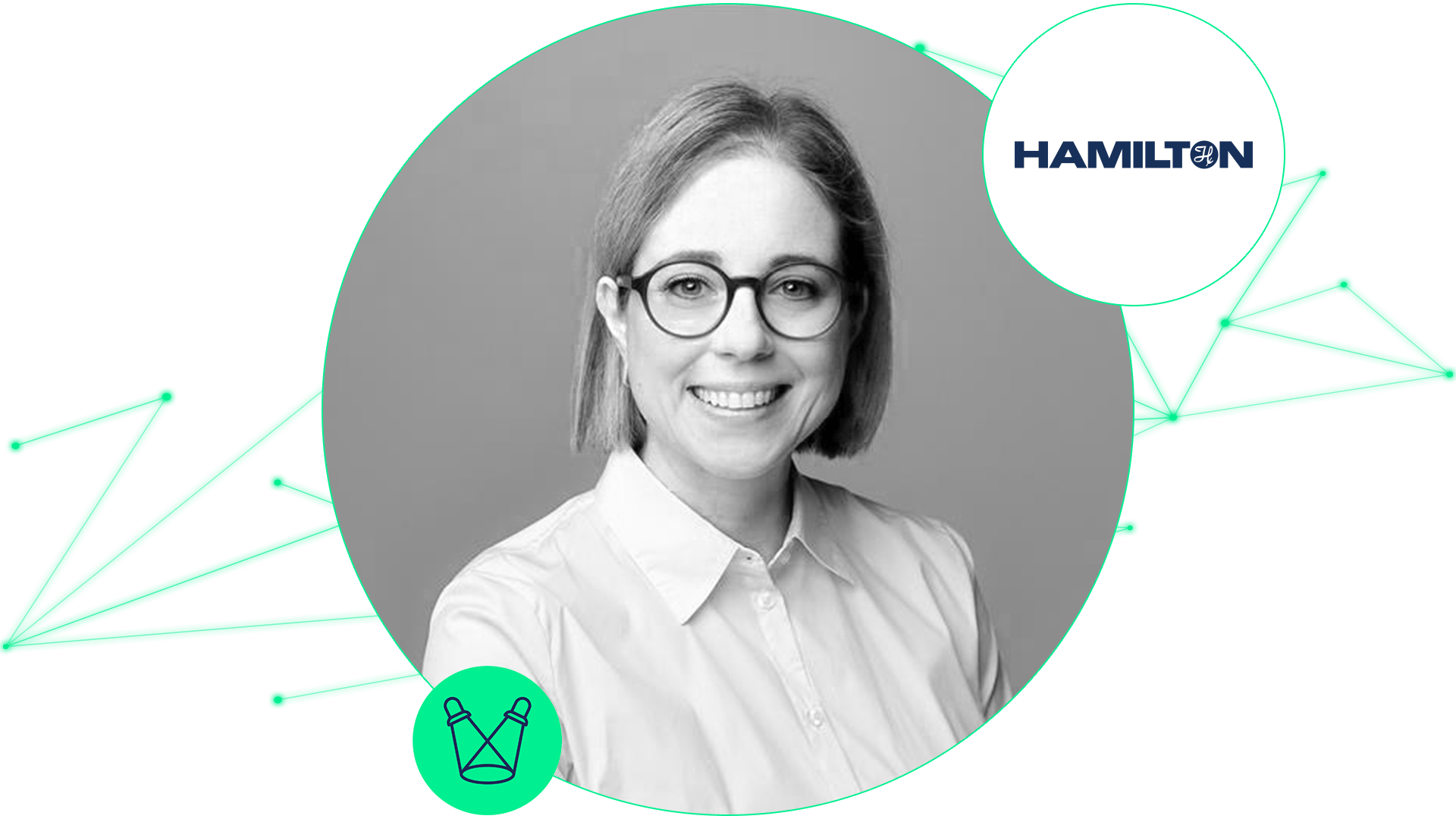 Smiling person with short hair and round glasses wearing a white collared shirt, beside the Hamilton logo