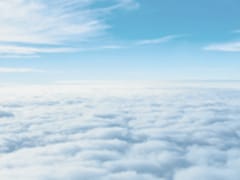 Aerial view above cloud layer under a blue sky