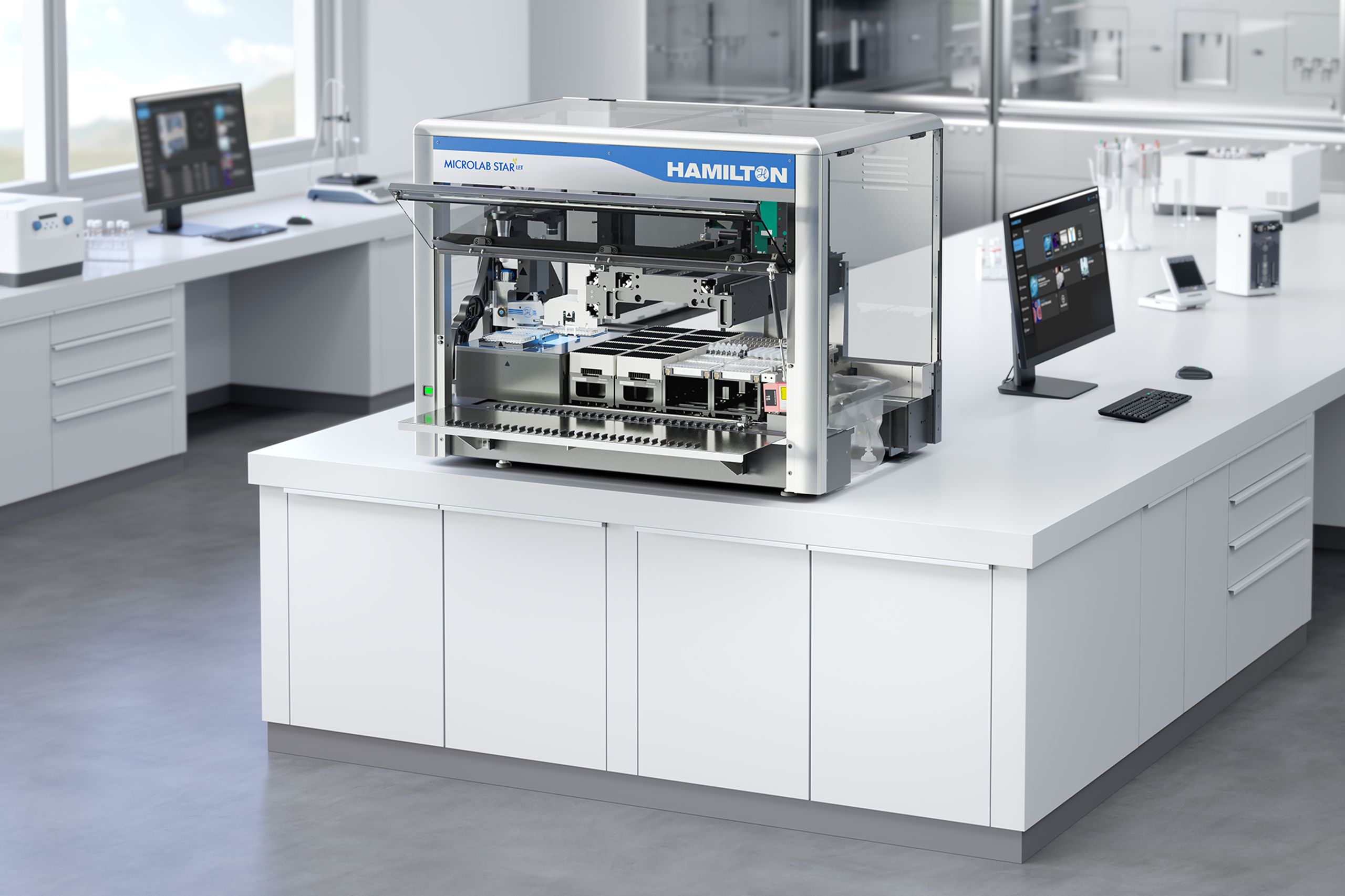 Hamilton Microlab STAR automated liquid handling workstation open on a laboratory benchtop with computer monitor