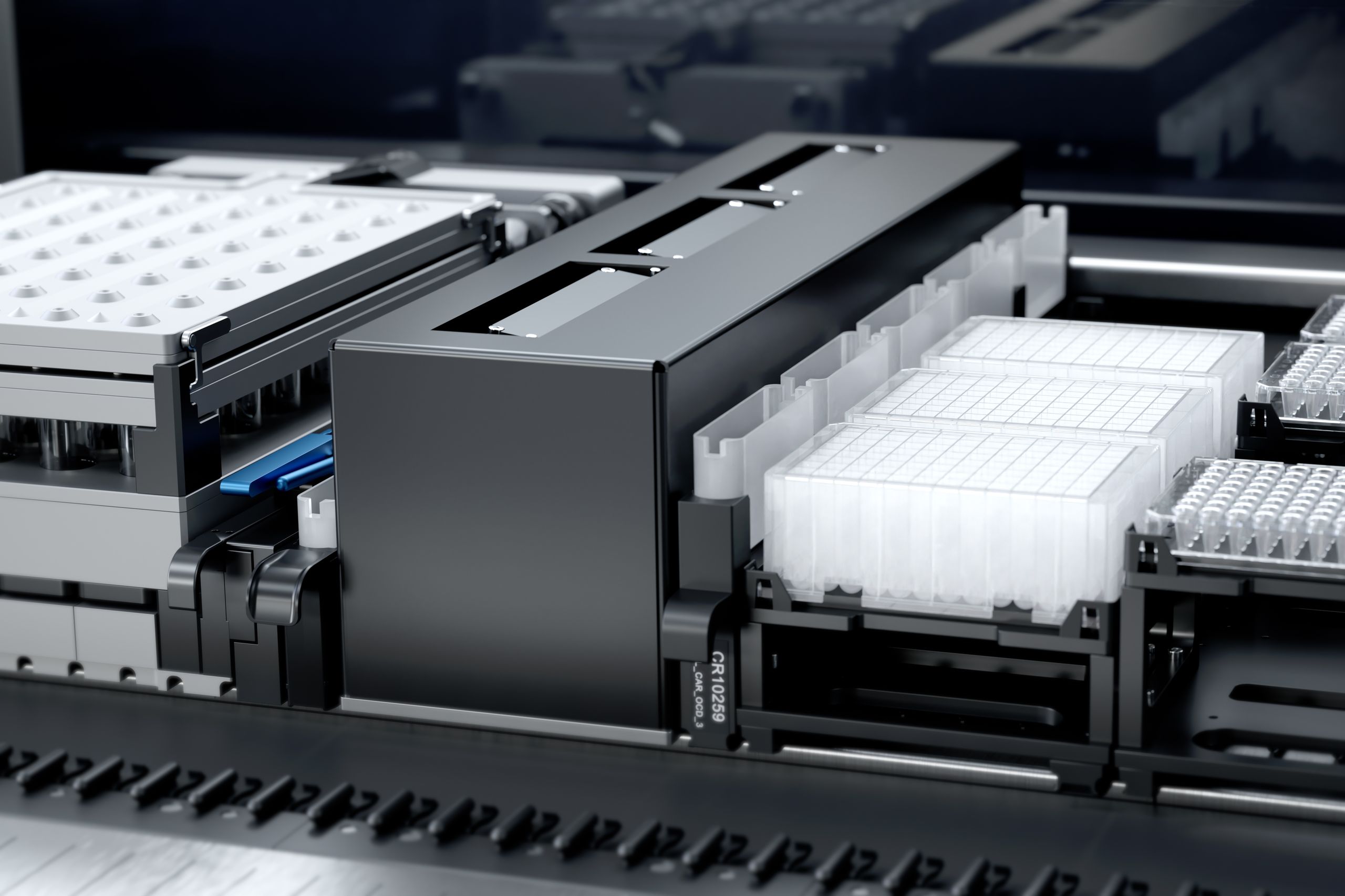Close-up of an automated liquid handling workdeck with microplate carriers, deep-well plates, and a wash station module