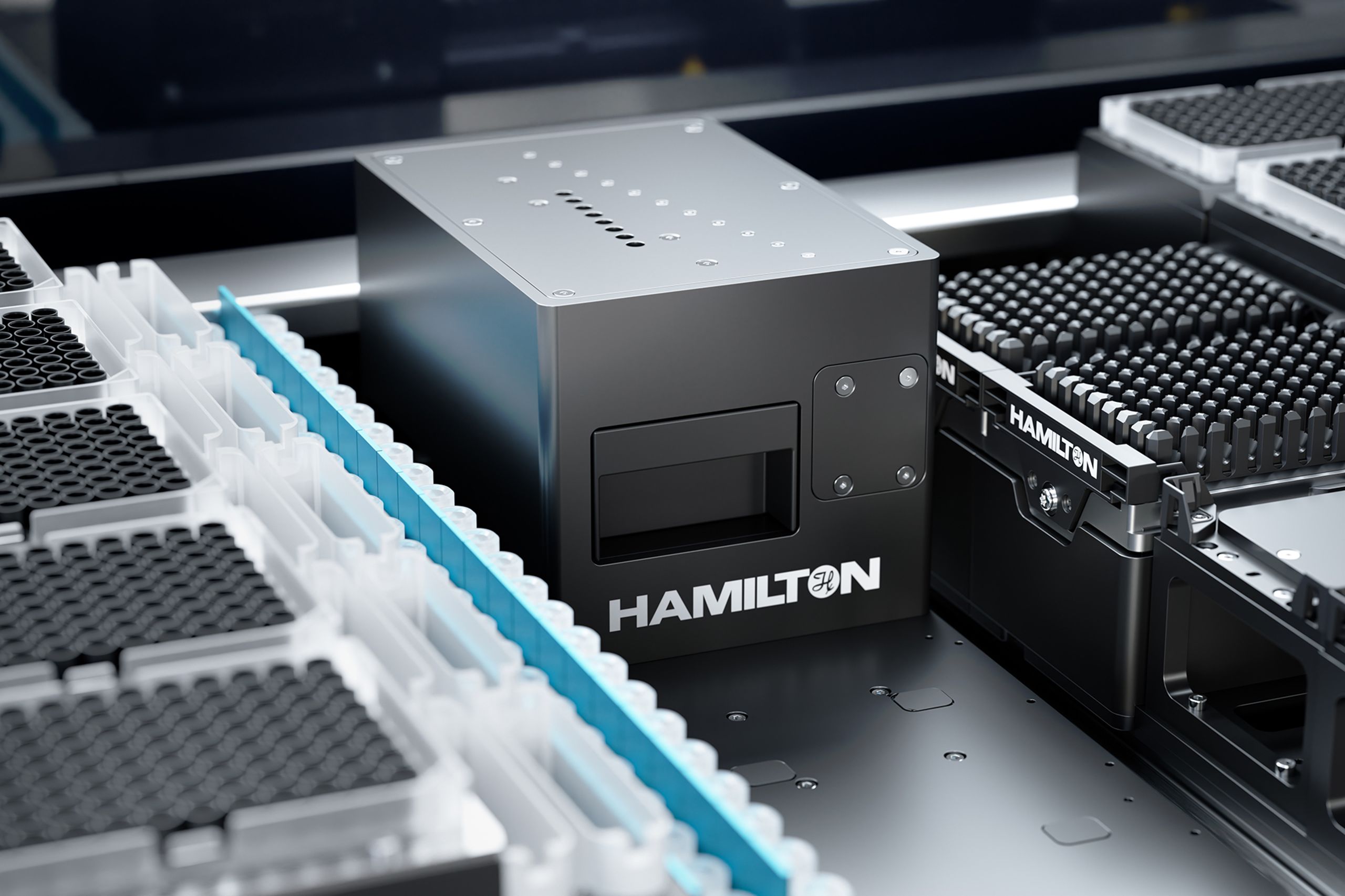 Hamilton-branded module on a liquid handler deck surrounded by tip racks and sample tube carriers
