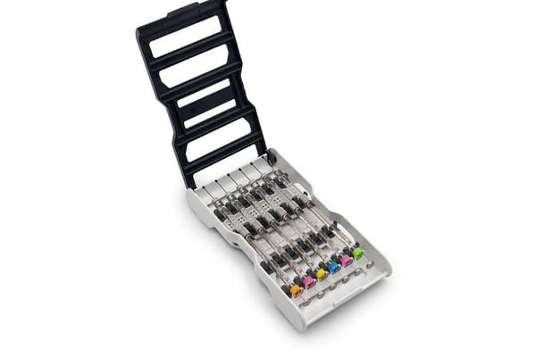 Open syringe storage case holding multiple Hamilton Neuros syringes with color-coded plunger tips
