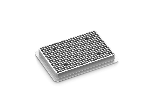 White 384-well microplate with dark circular wells, viewed from an isometric angle