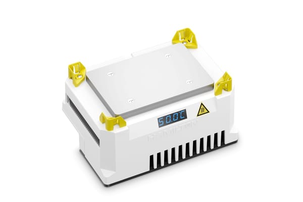 Hamilton heater cooler unit with metal plate, yellow corner guides, blue LED display reading 50.0°C, and heat warning label
