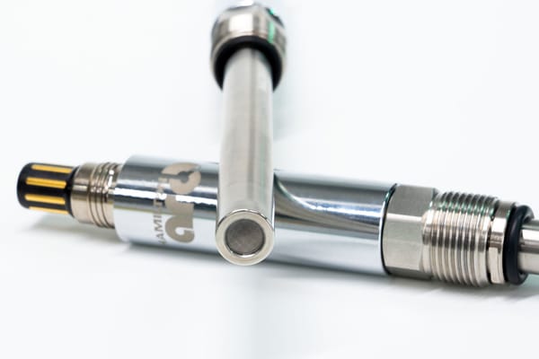 Two stainless steel sensors with threaded fittings and O-rings, one showing a hollow tube end, on a white background.