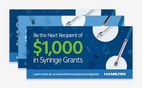 Three overlapping banners advertising $1,000 in Syringe Grants from Hamilton, with syringes shown on a blue background.