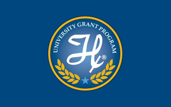 Hamilton University Grant Program seal with stylized H logo, gold laurel wreath, and star