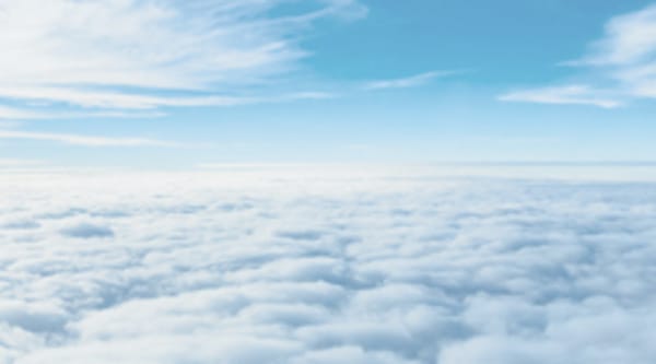 Aerial view above cloud layer under a blue sky