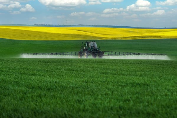 Tractor Spraying Pesticides on Crops