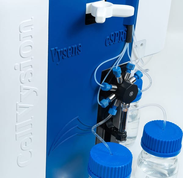 CellNvysion instrument panel with Vysens and cSPRi labels, fluidic tubing, manifold fittings, and media bottles