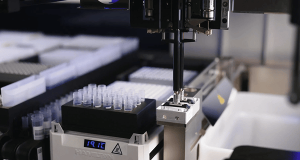 Automated liquid handling workstation with robotic pipetting arm over tube rack and microplate deck, 19.1°C display visible