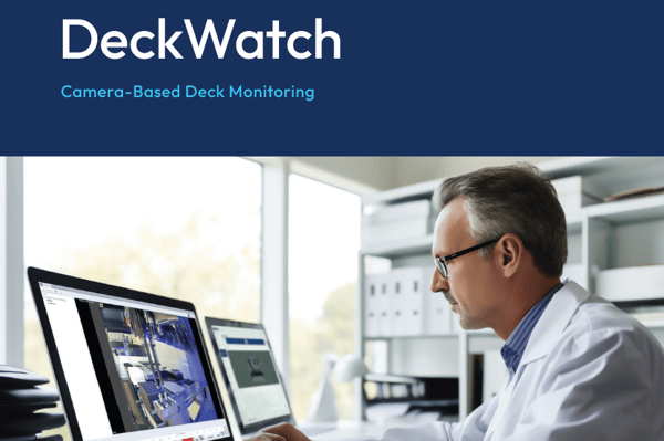 Scientist in lab coat reviewing camera-based deck monitoring software on a laptop