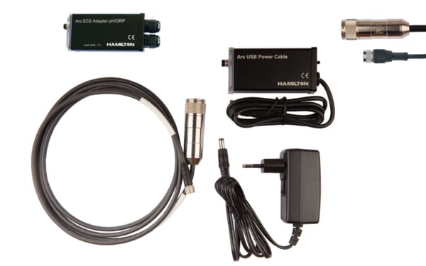 Hamilton Arc ECS Adapter pH/ORP, Arc USB Power Cable, sensor, power adapter, and cable on white background