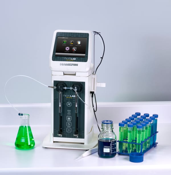 Hamilton MicroLab 600 Series diluter with controller, Erlenmeyer flask, reagent bottle, and tube rack with green solutions