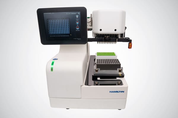 Hamilton automated tube decapper instrument with touchscreen display showing a 96-well plate grid, robotic decapping head, and green-capped sample tube rack