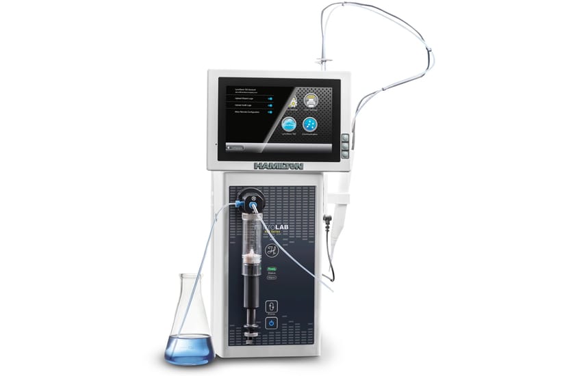 Hamilton MicroLAB dispenser with touchscreen display, syringe module, tubing, and Erlenmeyer flask containing blue liquid