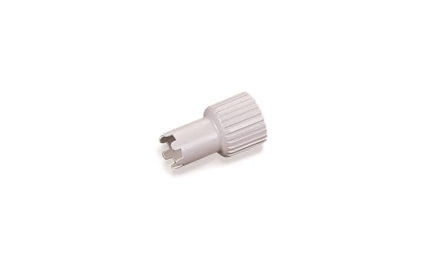 Gray knurled plastic calibration key with slotted tip