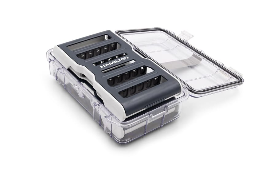 Hamilton Syringe Guard Kit in an open clear protective case with dark gray and white body, multiple slots visible