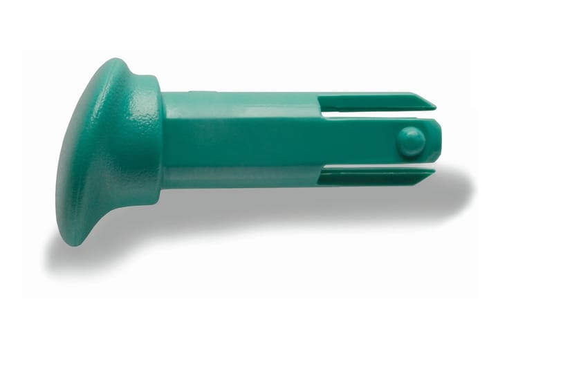 Green plastic plunger cap with split prongs and retaining nub, shown on white background