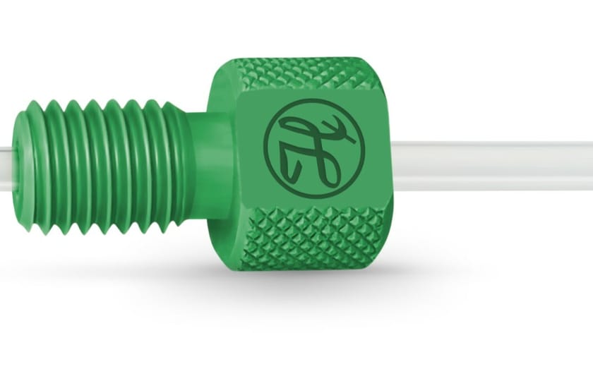 Green flangeless fitting with knurled body and threaded nose piece on clear tubing