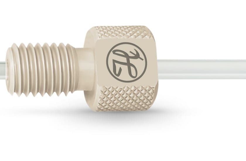 Flangeless natural PEEK fitting with knurled body and threaded nose, shown on clear tubing