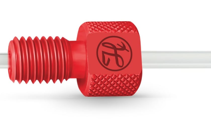 Red flangeless fitting with knurled body and threaded nose piece on a clear tube