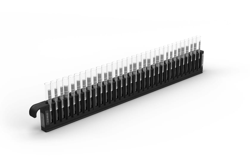 Black sample carrier rack holding approximately 32 barcoded sample tubes in upright positions.