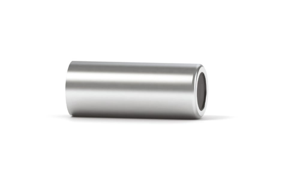 Hollow cylindrical metal spacer or bushing lying on its side, showing open bore on right end