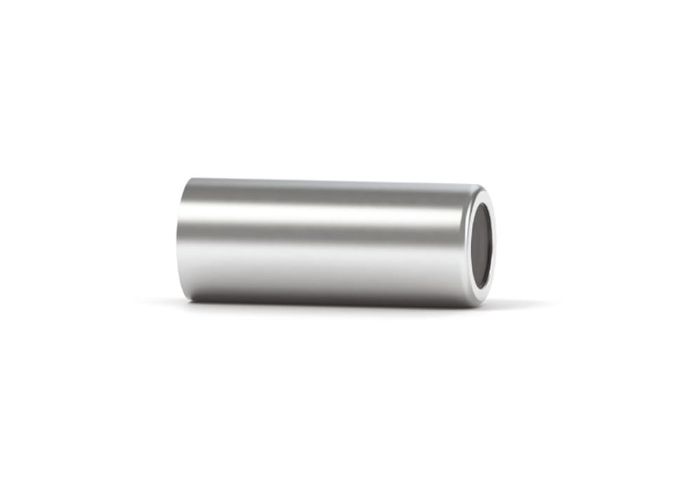 Hollow cylindrical metal spacer or sleeve lying on its side, showing open bore at one end